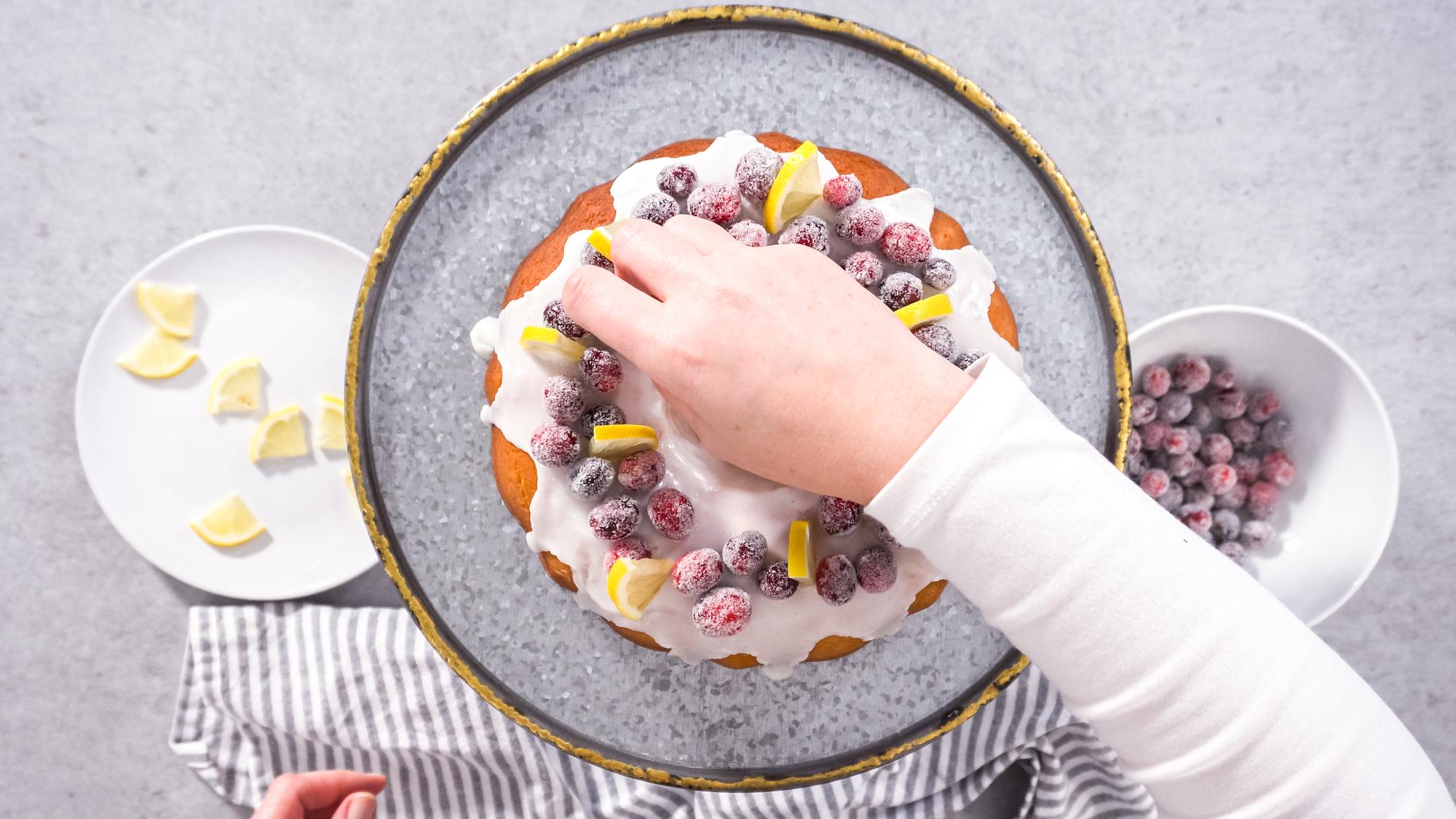 hands arranging plated dessert in studio