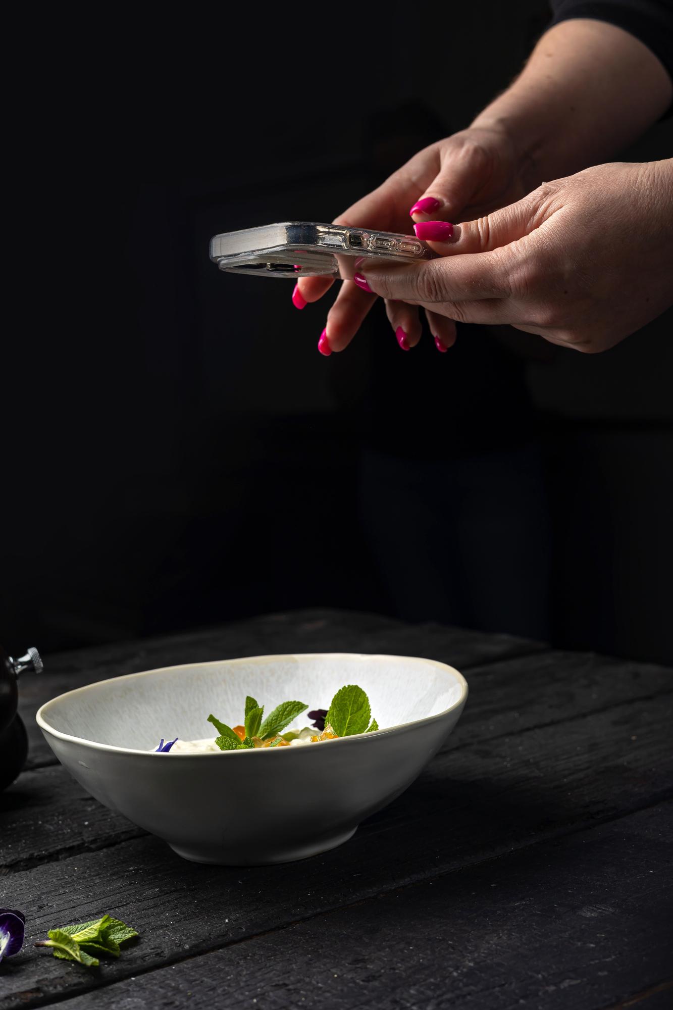 chef hands garnishing bowl